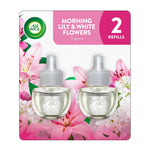 Air Wick Morning Lily & White Flowers plug-in refill twin bottles displayed on floral backing