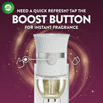 White Air Wick plug-in warmer with boost button highlighted and text instructing to tap the boost button for instant fragrance