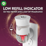 Air Wick plug-in device inserted in an outlet showing a red low-refill indicator and label about low refill indicator feature