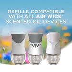 Illustration of three Air Wick scented oil devices with text stating refills are compatible with all Air Wick scented oil devices.