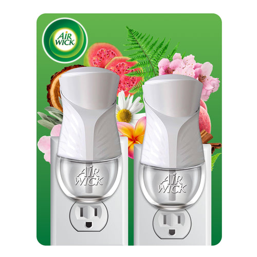 Two white Air Wick plug-in oil warmers shown inserted in outlets against floral backdrop