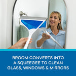 Person using the AirBroom as a squeegee to clean a bathroom mirror, product shown with blue head and white handle