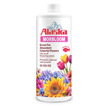 Isolated white bottle of Alaska Morbloom plant food with colorful floral label on a white background