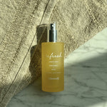 Allswell 'refresh' frosted spray bottle styled on marble surface with textured fabric backdrop and natural light