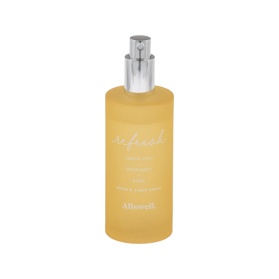 Frosted yellow glass spray bottle labeled 'refresh' Allswell room and linen spray with silver pump