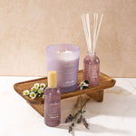 Product grouping on a wooden tray featuring Allswell 'Relax' mauve spray bottle, candle, reed diffuser and dried lavender accents.