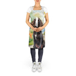 Model wearing an apron printed with a seated brown American Water Spaniel in a spring garden scene