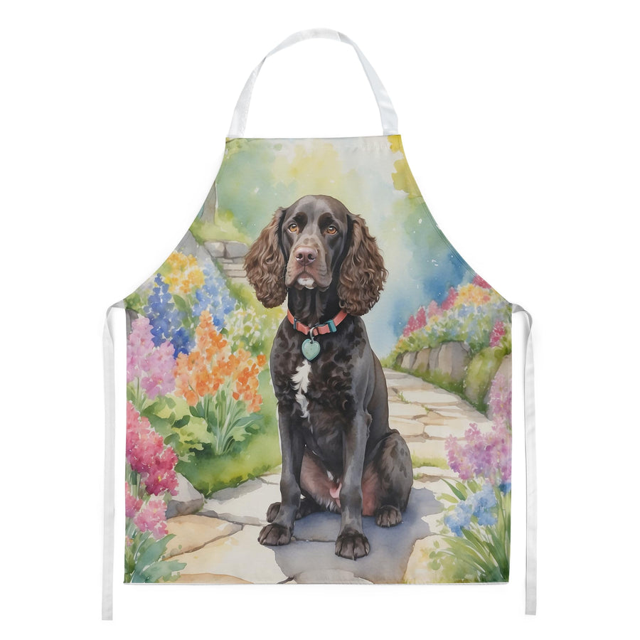 White apron printed with a seated brown American Water Spaniel against a colorful spring garden path