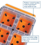 Angled close-up of an orange SuperSeed tray showing four cells and callout boxes pointing to rubber-coated handle and raised perimeter edge