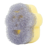 Angled side view of a purple textured scrubber attached to a yellow sponge, showing facial cutouts