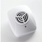 Angled product photo of a white ultrasonic pest repeller showing circular grille and red status light on plain background