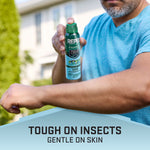 Person applying Repel Family aerosol spray to their forearm outdoors, product can visible in hand