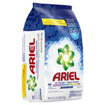Angled view of an Ariel powdered detergent bag with visible side panel text and green swirl logo on geometric blue pattern.