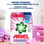 Ariel Downy powder detergent pack staged on a surface with folded pink towels and floral petals