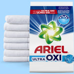 Ariel Ultra OXI powder bag product shot beside a stacked pile of white towels on blue background