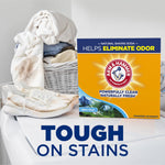 Arm & Hammer Alpine Clean powder detergent box shown on a laundry surface next to shoes and a laundry basket