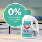 Arm & Hammer Baby detergent bottle on a countertop with a circular badge reading 0% preservatives, phosphates, dyes.