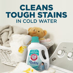 Arm & Hammer Baby detergent bottle placed near laundry basket and washing machine with headline about cleaning tough stains.