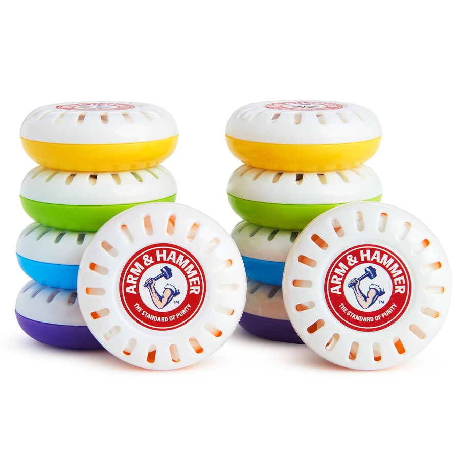 Stack of colorful round Arm & Hammer nursery freshener discs with white vented tops and visible logo