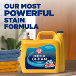 Yellow ARM & HAMMER Deep Clean detergent jug on a counter next to folded towels with large headline about powerful stain formula