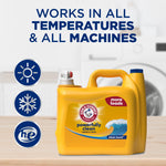 Yellow Arm & Hammer detergent jug on a table with icons and text 'WORKS IN ALL TEMPERATURES & ALL MACHINES'