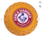 Close-up of a single orange vented Arm & Hammer Odor Busterz ball with the brand logo on top.