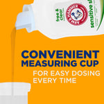 Close-up of ARM & HAMMER bottle pouring liquid into a measuring cup with text “Convenient measuring cup for easy dosing every time”