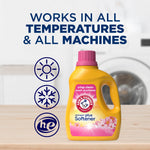 Arm & Hammer yellow detergent plus softener bottle on a table with icons indicating works in all temperatures and all machines