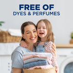 Smiling woman holding a laundry basket and child in a laundry room scene with 'Free of Dyes & Perfumes' text above.