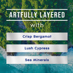 Artwork panel reading "ARTFULLY LAYERED" with descriptors Crisp Bergamot, Lush Cypress, Sea Minerals over coastal and forest imagery