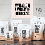 Assortment of Wipe That Tush packaging in different sizes on a tiled counter with a headline noting availability in other sizes.