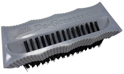 Gray plastic hand brush labeled 'De-Greaser' with black stiff bristles and ribbed grip edges