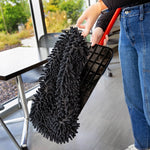 Person holding a red-handled mop while attaching a black microfiber chenille refill to the mop base