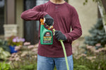 Person connecting an Ortho WeedClear ready-to-spray bottle to a garden hose using orange connector