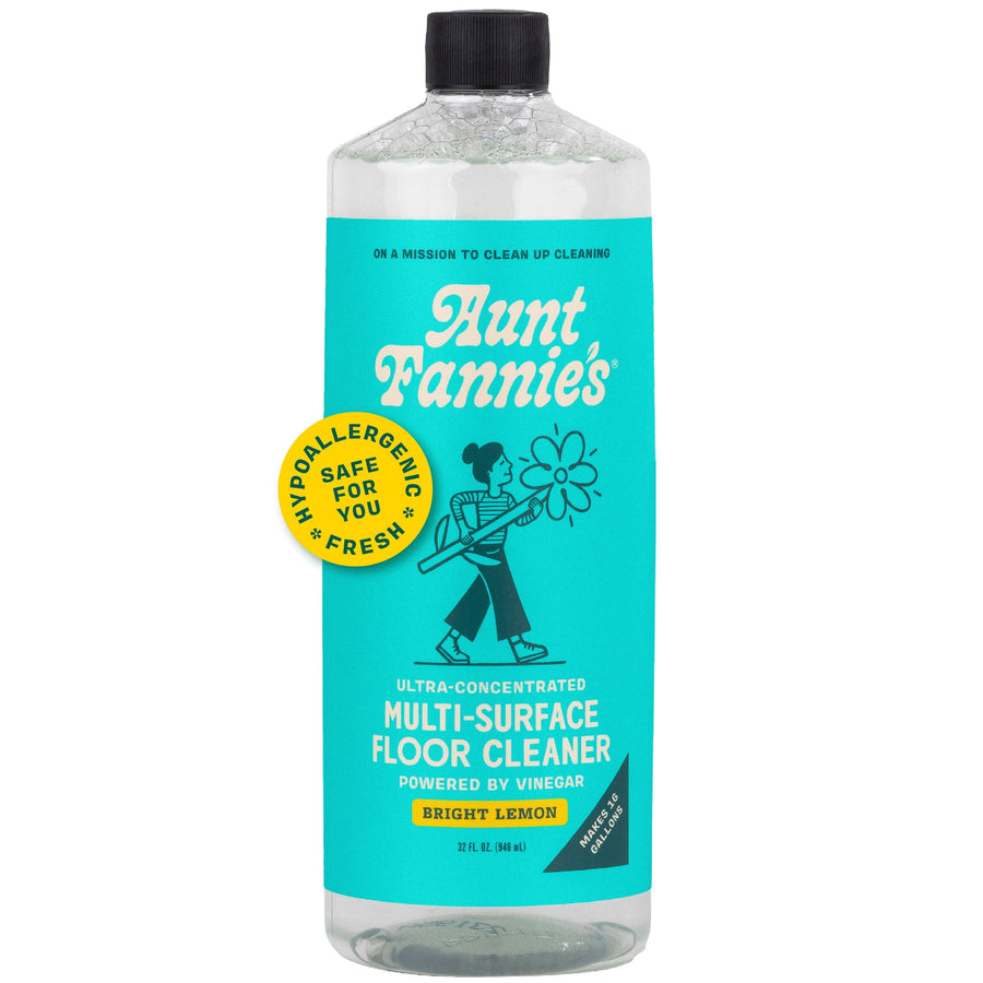 Clear bottle of Aunt Fannie’s bright turquoise-labeled multi-surface floor cleaner with black cap and label badge
