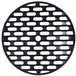 Black round removable grit guard with elongated oval drainage slots and central hole on white background