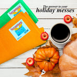 Top-down styled scene with orange and green Secamax shammy cloths beside a cup of coffee, small pumpkins and autumn leaves.