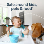 Baby at a highchair feeding a dog with headline text stating safe around kids, pets & food in a home scene