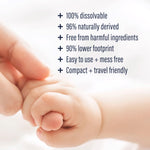 Close-up of an adult and baby hand with bulleted product benefit text about dissolvable, natural and travel friendly
