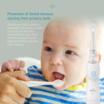 Lifestyle image of a baby being fed with a spoon and a Little Martin's electric toothbrush pictured at right