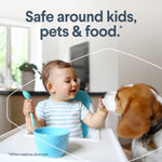 Lifestyle image of a toddler in a high chair reaching toward a dog with headline text saying safe around kids, pets & food.