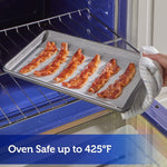 Bacon strips cooking on a parchment-lined baking sheet being placed into or removed from an oven