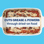 Top-down view of a baked-on, greasy rectangular casserole dish with text claiming it cuts grease and powers through dried-on food