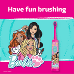 Promotional graphic with illustrated Barbie characters, paw logo and a pink Barbie electric toothbrush beside the headline 'Have fun brushing'.