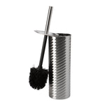 Chrome swirled-texture toilet brush holder with a slim handle and a black-bristled brush leaning against the rim