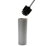 Silver hammered-texture cylinder holder with gray-handled toilet brush suspended above showing round black bristle head