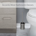 Stainless steel hourglass toilet brush and holder placed beside a toilet in a bathroom setting with text overlay
