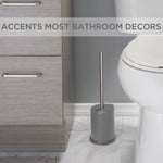 Bathroom lifestyle scene showing a grey toilet brush and holder placed on floor next to toilet and vanity