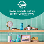 Shelved bathroom scene with Tom’s of Maine products, toothbrush holder, clock and decorative items under a brand headline.
