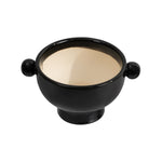 Angled overhead view of a glossy charcoal ceramic planter showing light beige interior glaze and twin knob handles